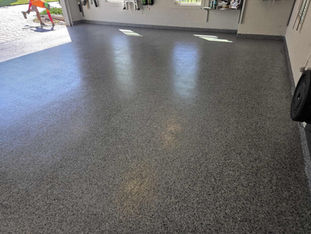 Nightfall Garage Epoxy Flooring with worker in the background