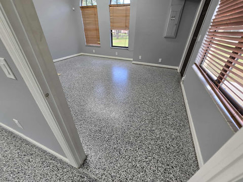 Polished Domino flake epoxy surface showing a smooth finish and a contemporary monochrome pattern, ideal for stylish, high-traffic environments.