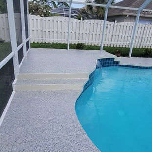 Durable epoxy flooring on a pool deck, resistant to cracks, water, and heavy traffic.