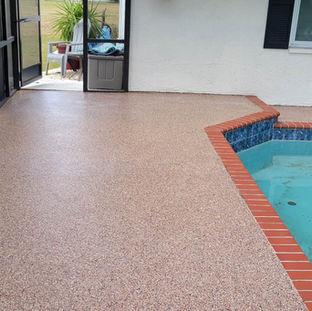Seamless epoxy flooring on a pool deck, providing a smooth and continuous surface free of joints.