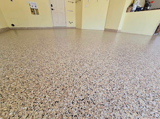 Outback Garage Flooring Polyaspartic Coatings Close up with yellow walls in background that compliment the floor choice very well