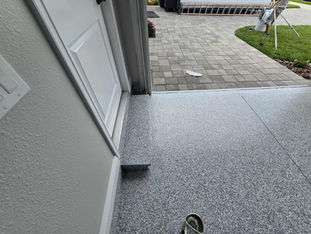 Detailed image of Domino epoxy flooring, highlighting the consistent distribution of polymer flakes in neutral tones for a clean and durable surface.