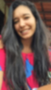 Photo of female author Ana wearing blue and pink shirt.