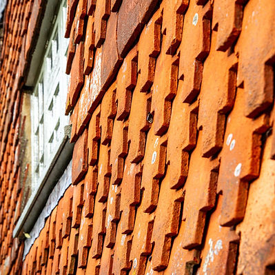 Hanging terracotta clay wall tiles on a traditional property