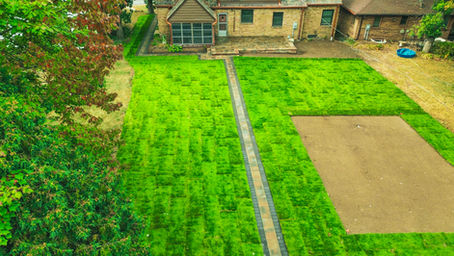 Aerial view of St. Paul backyard with large stepping-stone walkway across lawn leading to a small shed.