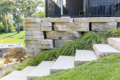a stone wall with stairs leading up to it and a fence that says ' sterling ' on it