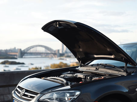 Car broken down  with hood up, Sydney harbour bridge is in the background