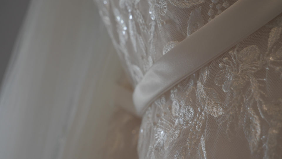 cinematic shot of beautiful lace wedding dress close up