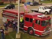 Camden Township firefighters gathered near a fire engine and American flag