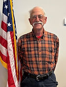 Richard Zehring next to the American flag