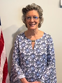 Linda Fliehman next to the American flag