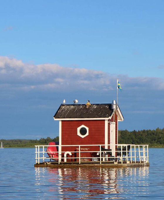 Red floating house on a lake, an underwater room experience