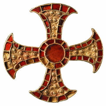 A close-up image of the Trumpington Cross, a jewelled cross made from gold with inlaid garnets. The central circular garnet is much larger.