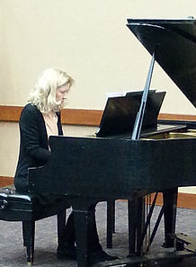Mary Vanderslice performing at the pianoat Aurora Central Library.