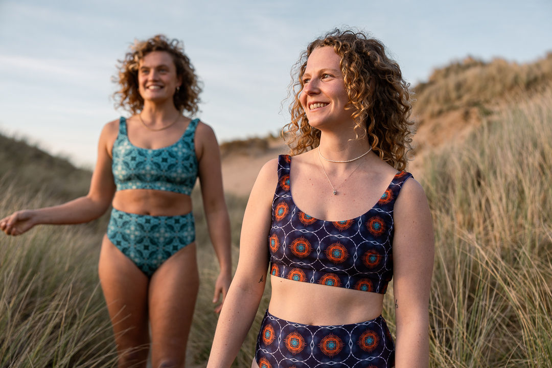 woman modelling bikini top on beach front view