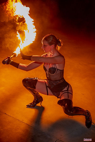 Fire Dancer Madison McIntosh performs a fire sword dance at an event in Miami, Florida.