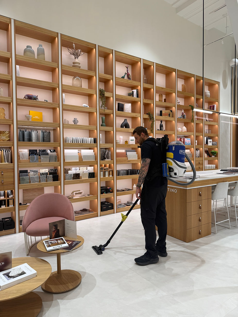 Cleaner maintaining retail store shelves and interior in Melbourne shop