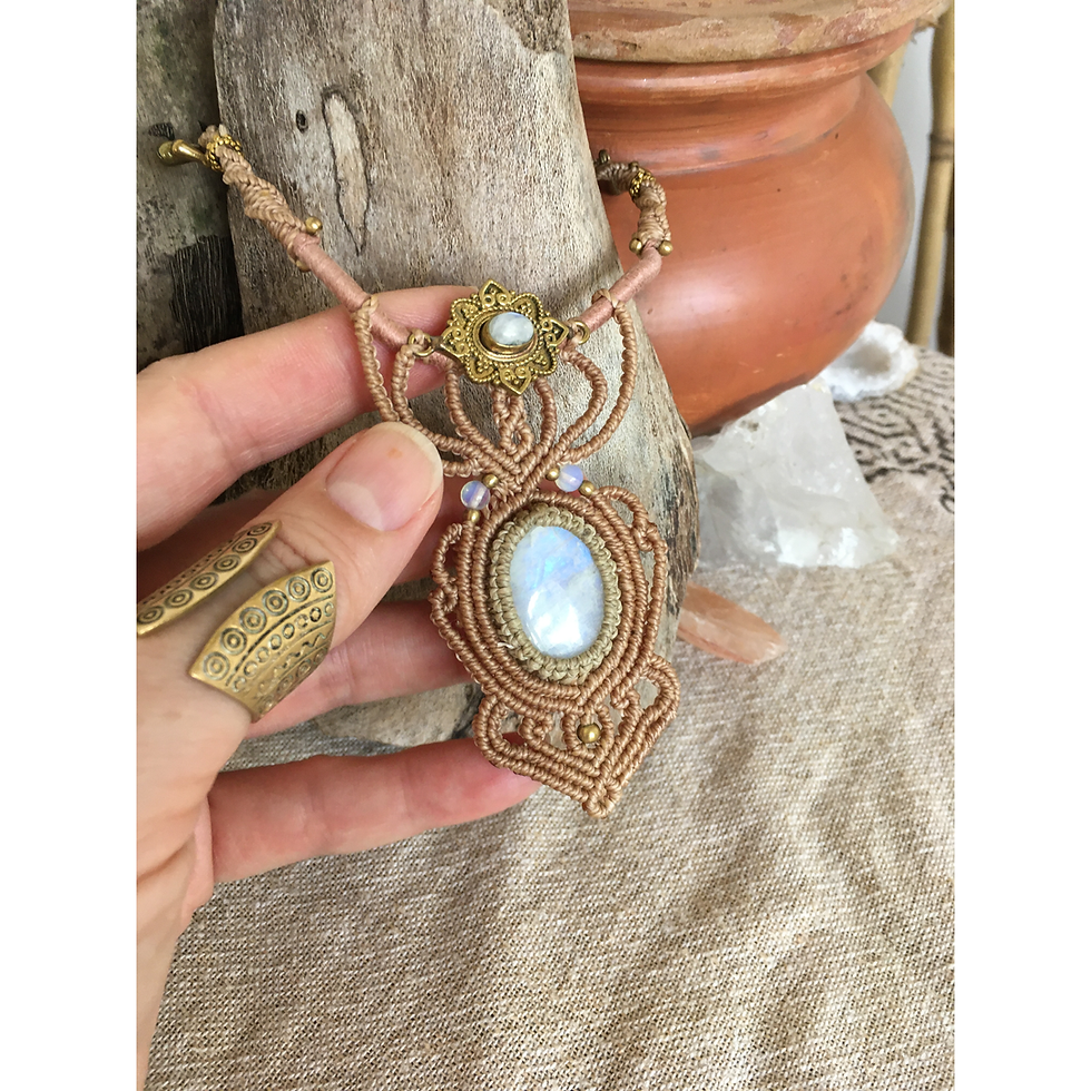 Thumbnail: Hand holding moonstone macramé necklace with pink cotton choker-style band