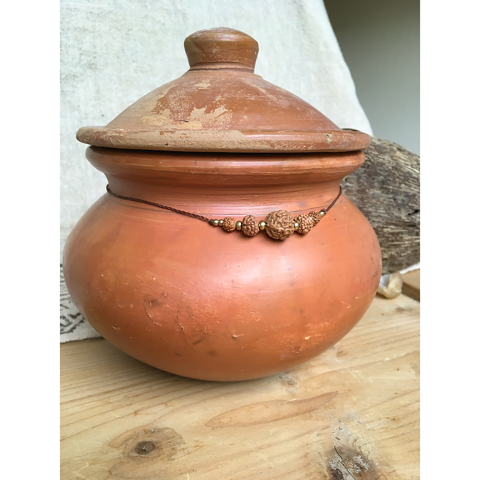 Thumbnail: Dark rudraksha necklace displayed shorter on terracotta pot showing adjustable length
