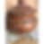 Seven chakra necklace displayed on a terracotta pot on a wooden surface with cream textured fabric
