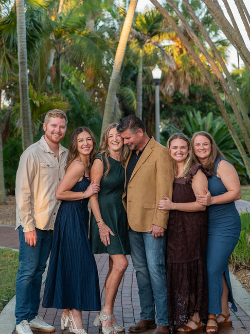 Extended family smiling together during an outdoor family portrait session in St. Pete, Florida