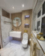 Modern bathroom renovation with marble and gold