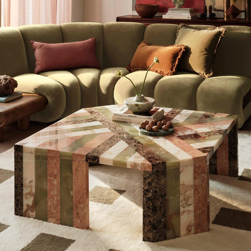Modern living room with a striped coffee table and green sofa