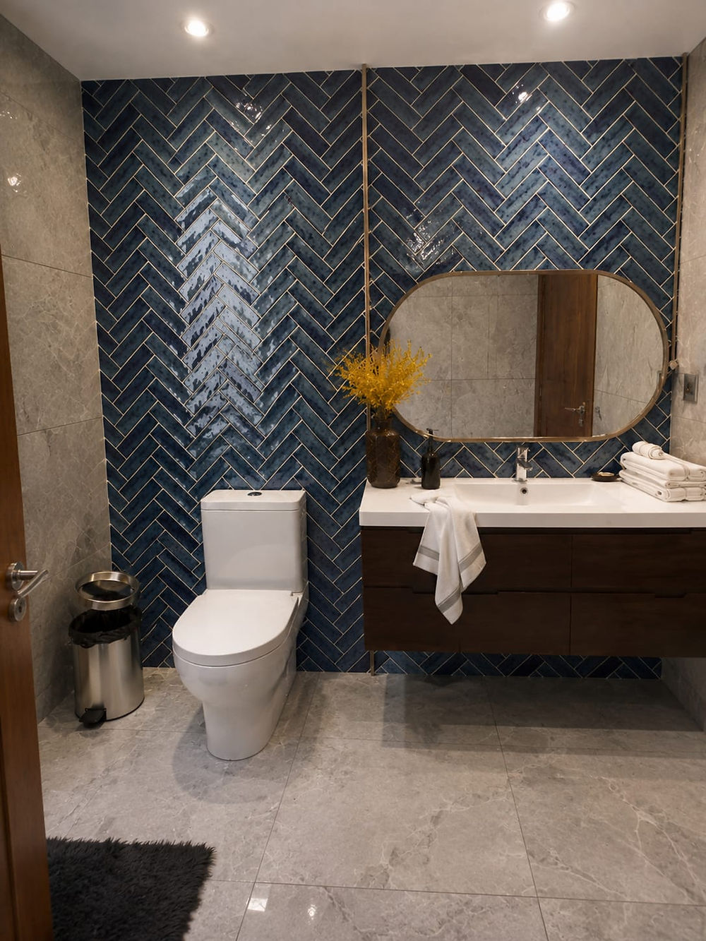 Modern bathroom with blue tile, floating vanity, and bespoke basin worktop