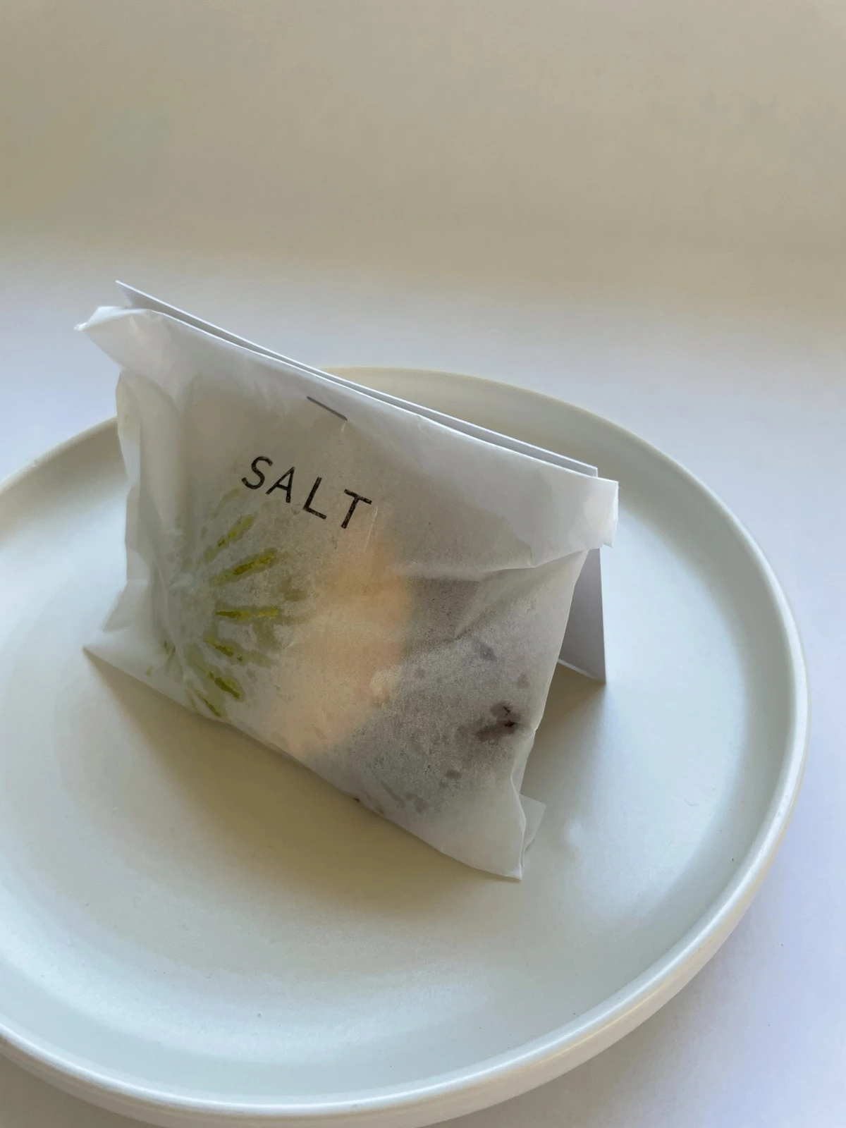 A sealed SALT mini bag on a ceramic plate
