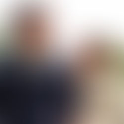 A couple laughing together in  a park 