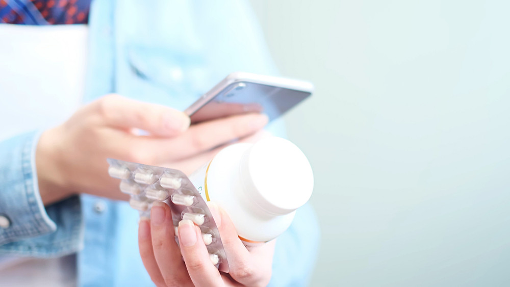 woman looking at medication