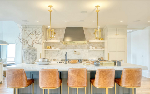 Home kitchen with light cabinets and tan barstools