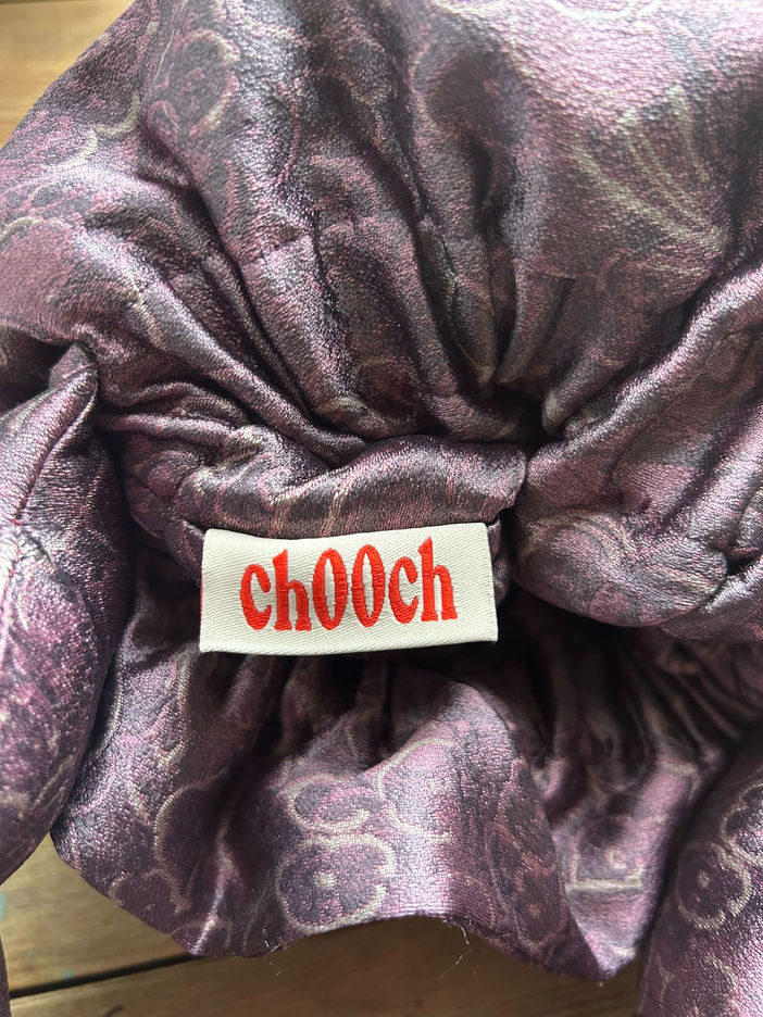close-up of a chooch woven label with logo stitched inside a bag.