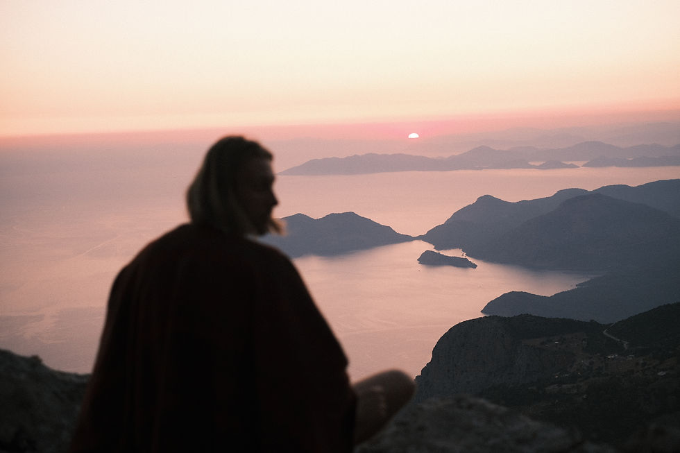 Man watching sunset on top of the mountain