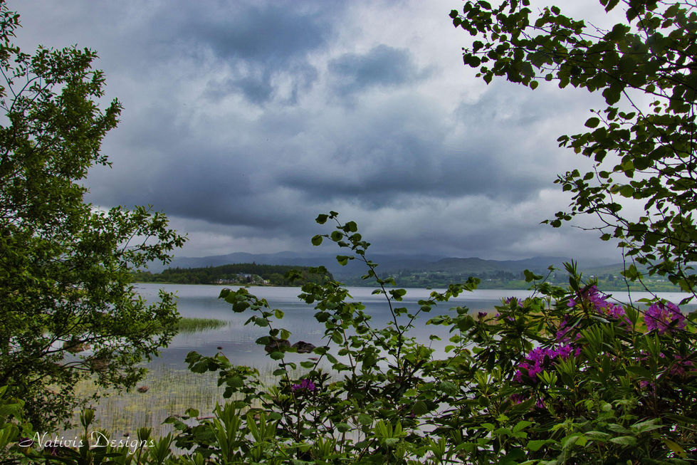 Lough Eske Lake in Donegal Ireland with lush green trees and a mountain scape in the background