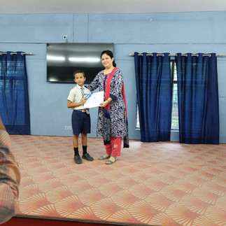 Teacher handing over a certificate to a student