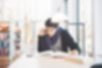 An image of a young man studying in a library