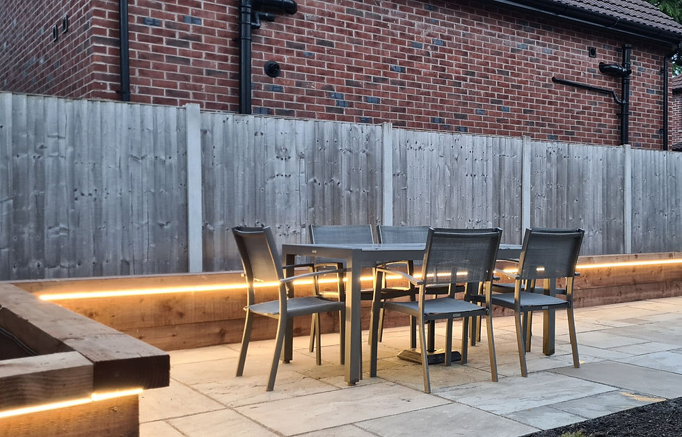 Eye-level view of a stone patio with garden furniture in a backyard