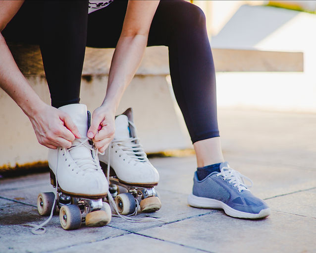 woman-sitting-tying-up-roller-skates.jpg