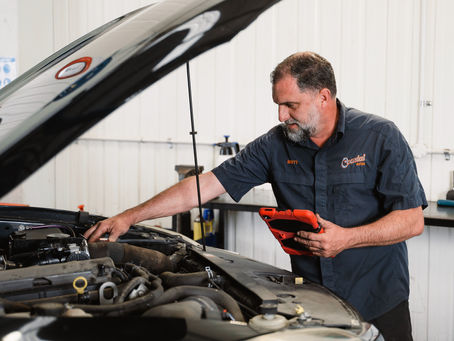 Mechanic inspecting vehicle