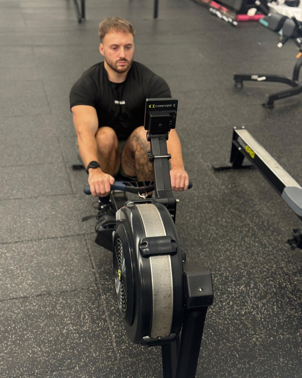 Personal trainer on rowing machine.png