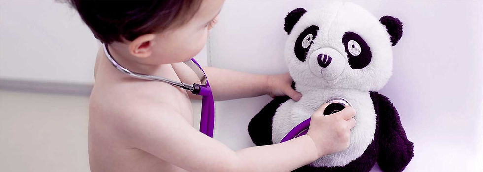 baby playing doctor with teddy