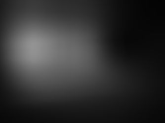 A solitary figure seated in a vast empty room, light falling through institutional windows.