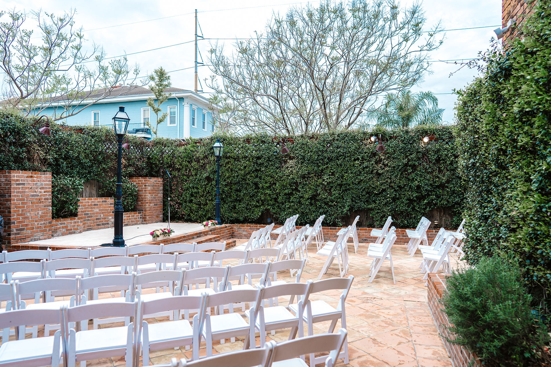wedding ceremony set up in garden courtyard