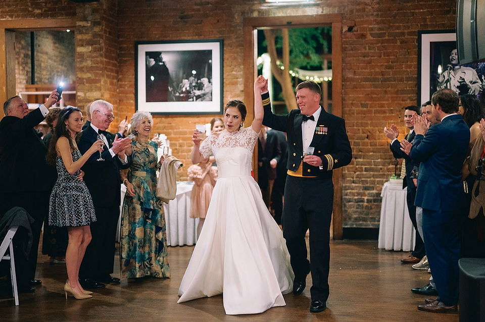 bride and groom enter reception in celebration