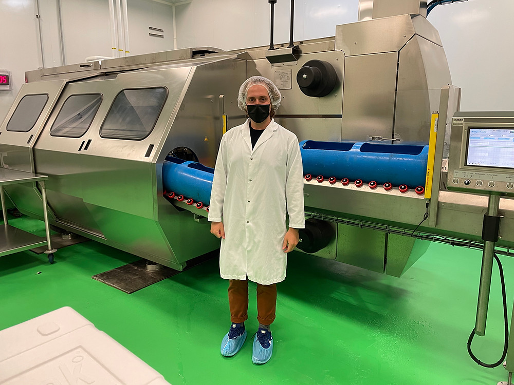 PhD Student Michael Pitino standing in front of High-Pressure Processing Equipment