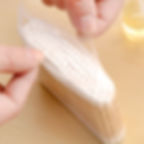 Opening a pack of bamboo cotton swabs for makeup.
