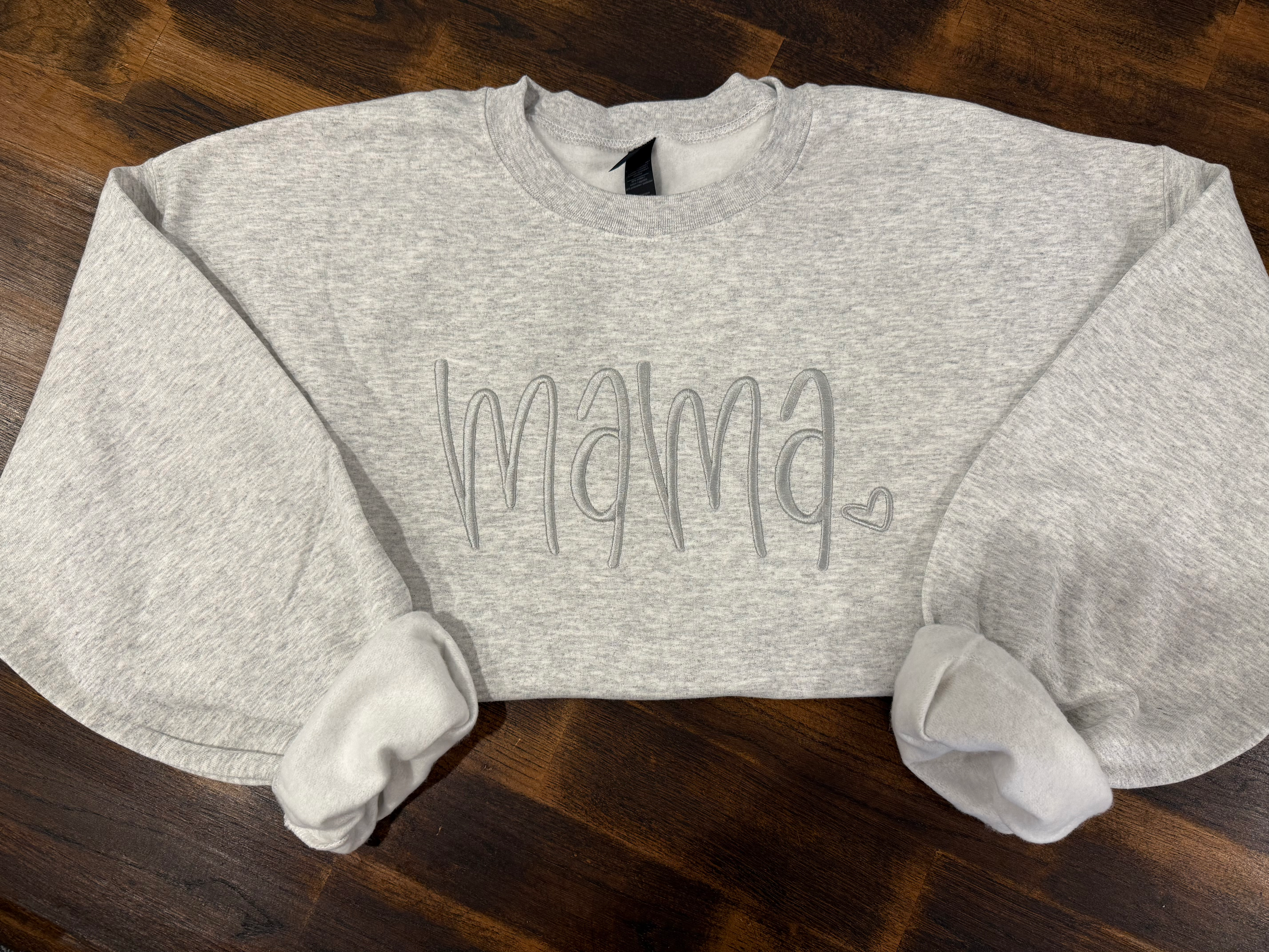 Personalized embroidered name sweater featuring clean stitching and modern lettering