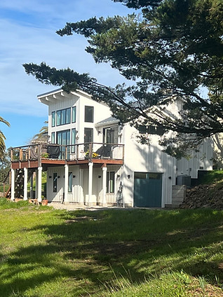 White house nestled among trees on a sunny hill, Sonoma.