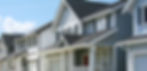 Row of houses painted blue, white and gray